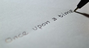 Pen writing “Once upon a time” on paper